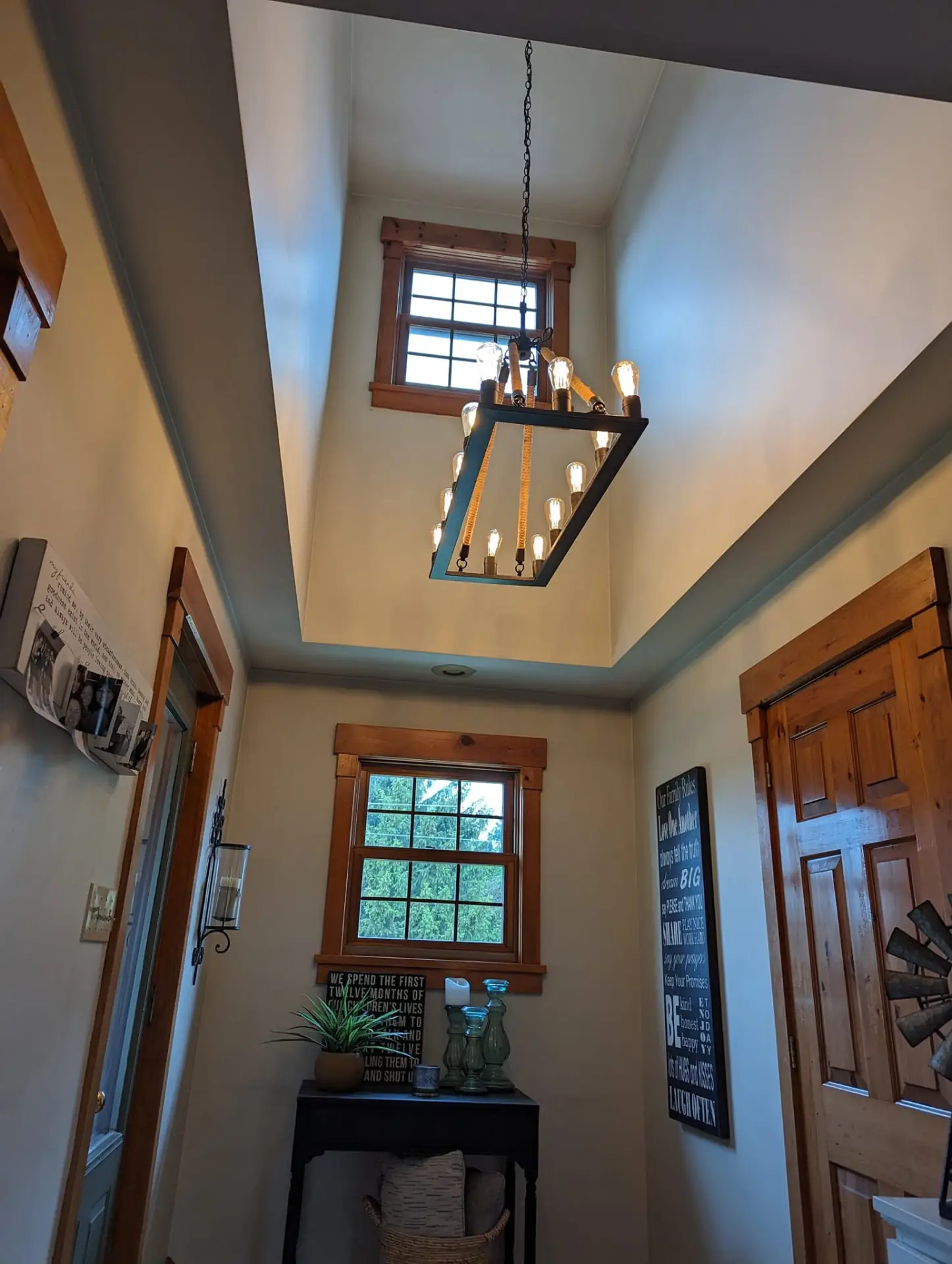 Entryway with a tall rectangular chandelier in a vaulted ceiling